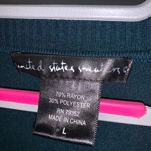 Women’s button up teal blue sweater.